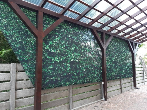 Rideau de jardin robuste avec imprimé de feuilles vertes, installé sur mesure sous un toit de terrasse