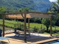 Pergolă din lemn cu jaluzea romană bej 2,5x4 m deasupra terasei de lângă piscină