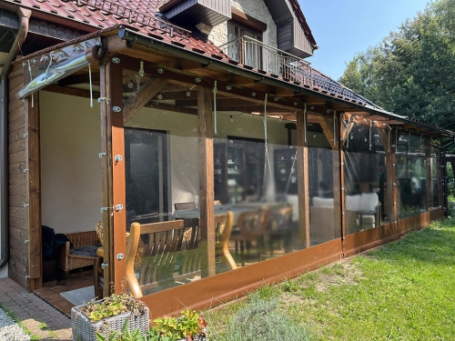 Przeźroczysta plandeka na wymiar osłaniająca drewniany taras przed deszczem i wiatrem