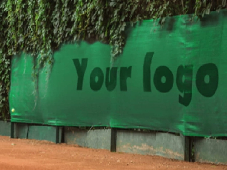 Lona verde para pista de tenis a medida con el texto Your logo impreso bajo un seto