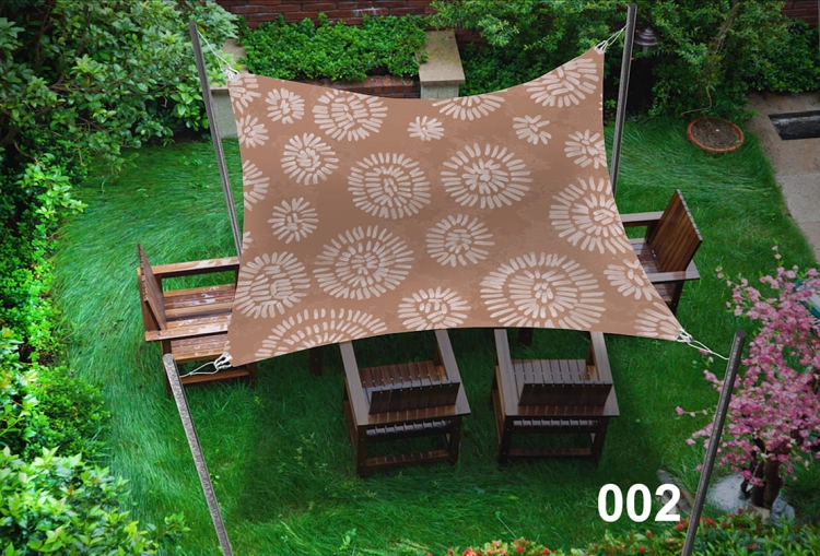 Voile d'ombrage imperméable marron 3x5 m avec motif floral clair au-dessus d'un salon de jardin sur l'herbe