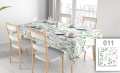 Vlekafstotend reclametafelkleed met kleurrijke plantenprint op een eettafel met witte stoelen