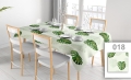 Vlekafstotend reclametafelkleed met monstera-bladeren print op een gedekte eettafel