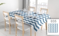 Vlekafstotend reclametafelkleed met blauw-witte zigzagstrepen op een tafel met servies in een lichte eetkamer