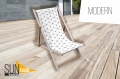 Promotionele ligstoel met geometrisch patroon op houten frame op een terras met tekst Modern en Sun Shade logo