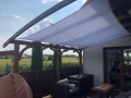 Vela de sombra cuadrada impermeable 3x3 m montada en una terraza de madera como protección solar Premium